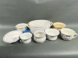 a lot of dishes and cups sitting on a table