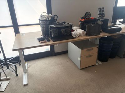 a desk with a lot of electronics on it