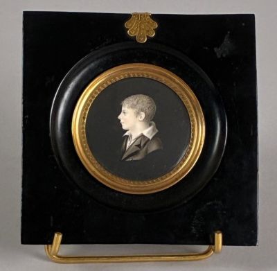 portrait of a man in a suit and tie in a black and gold frame