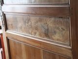 a wooden cabinet with a glass door in a room