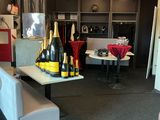 bottles of champagne and bottles of wine on a table in a living room