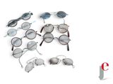 several pairs of glasses are arranged in a circle on a white surface