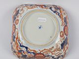 a plate with an orange, blue and white design on it