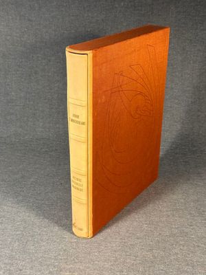 an old book sitting on top of a table next to a gray background