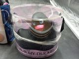 a rubber duck in a cup with a toothbrush and toothpaste