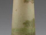 a vase with a painting on it sitting on a table