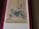 a painting of a woman in a green dress on a red table
