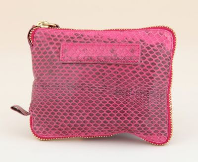 a close up of a pink purse on a white background