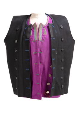 a black vest with a purple shirt underneath it
