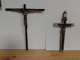 a cross and a rosary on a table next to a wall