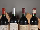 three bottles of red wine are lined up on a table
