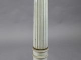 a white pillar with a wooden top on a gray background