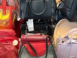 a lot of purses that are sitting on a table