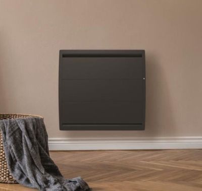 an electric heater sitting on top of a wooden floor next to a chair