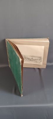 an open book with a green cover on a table