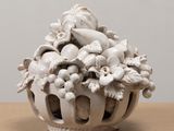 a white vase with a bunch of flowers inside of it