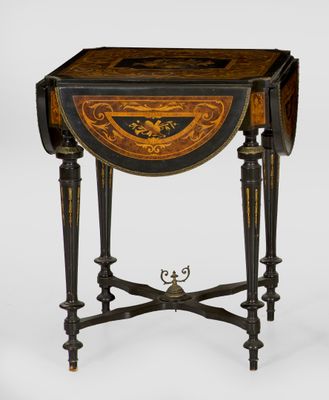 a small table with a black and gold decoration on the top