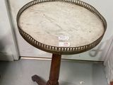 a small table with a marble top on a stand