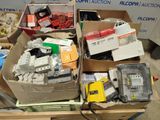 many boxes of assorted electrical equipment sitting on a table