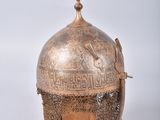 an old helmet with a chain around the neck and a chain around the neck