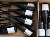 many bottles of wine in a box on the floor
