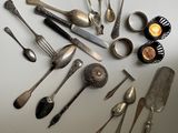 a lot of silver spoons and spoon spoons on the table
