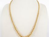a gold beaded necklace on a mannequin mannequin mannequin mannequin mannequin mannequin mannequin mannequin mann