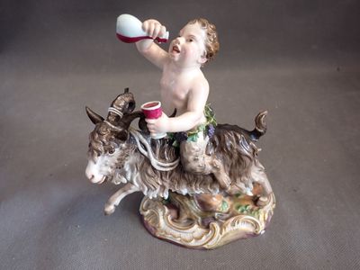 a figurine of a boy on a donkey drinking from a cup