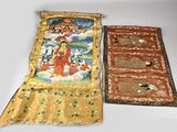 two pieces of cloth on a table with a painting on it