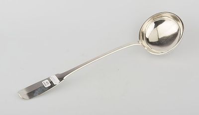 silver plated spoon with handle and spoon rest on a white surface