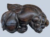 a statue of a dog that is laying down