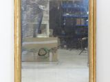 a mirror that is sitting on the floor in a room