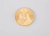 an image of a close up of a gold coin on a white surface