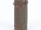 an old metal trash can sitting on top of a white surface