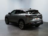 the rear end of a grey suv parked in a garage