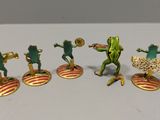 five figurines of a frog playing a game of tennis
