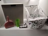 a white shelf with a trash can and a trash can and a trash can on it