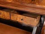 a wooden desk with two drawers underneath it