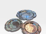 three different colored plates sitting on top of each other on a white surface