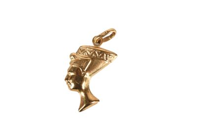 a close up of a gold pendant on a white background