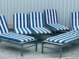 six lounge chairs with blue and white striped cushions