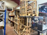 a large amount of wood stacked on a shelf in a warehouse