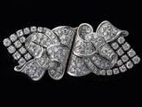 a close up of a diamond broochle on a black background
