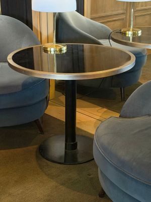 two chairs and a table with a lamp on it