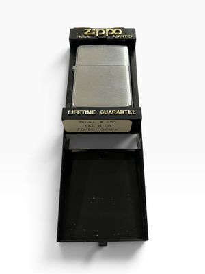 zippo lighter in a black box on a white surface