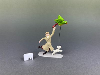 a figurine of a man with a bird and a dog