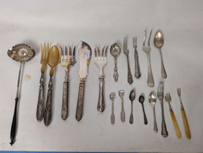 a lot of silver spoons and forks on the table
