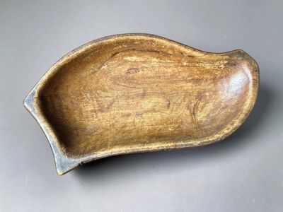 a close up of a wooden bowl on a table