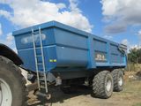 a blue dump truck parked on the side of the road