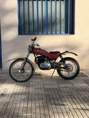 a motorcycle parked in front of a building next to a window